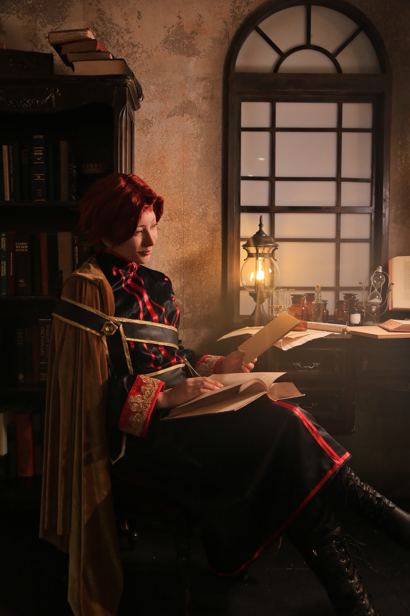 Hartmut cosplay sitting at the desk with moody light